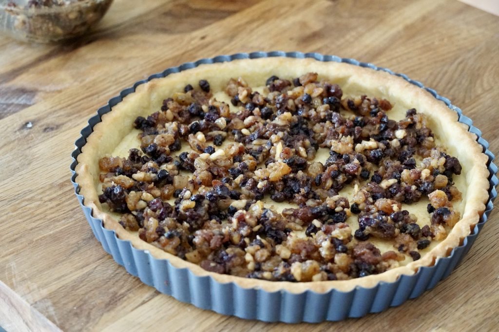 The pastry shell topped with mincemeat.