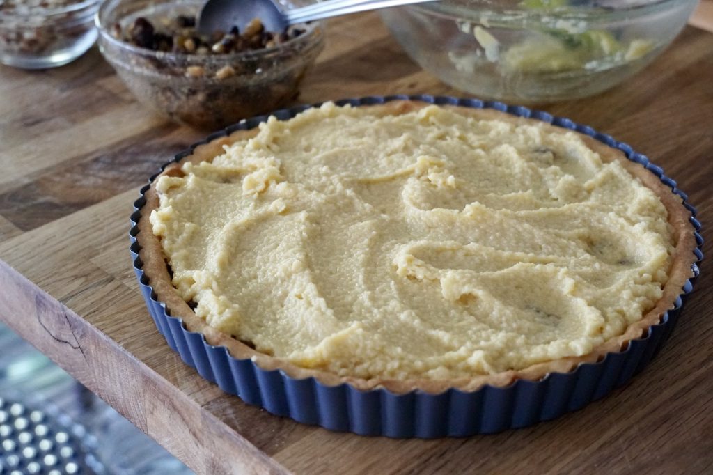The creamy frangipane mixture spread lightly over the tart.