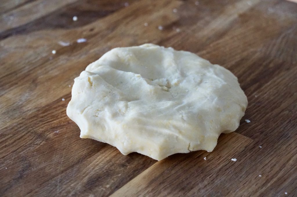 A disc of shortcrust pastry dough just after being created.