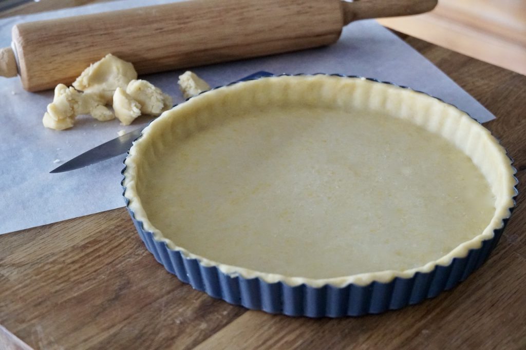 The shortcrust pastry shaped into the fluted tart pan.
