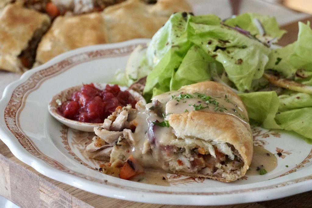 A portion of Turkey Leftovers Galette served with a simple salad.