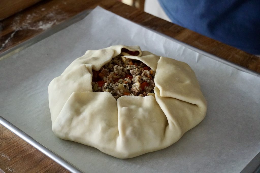 The galette dough folded up to enclose the filling.