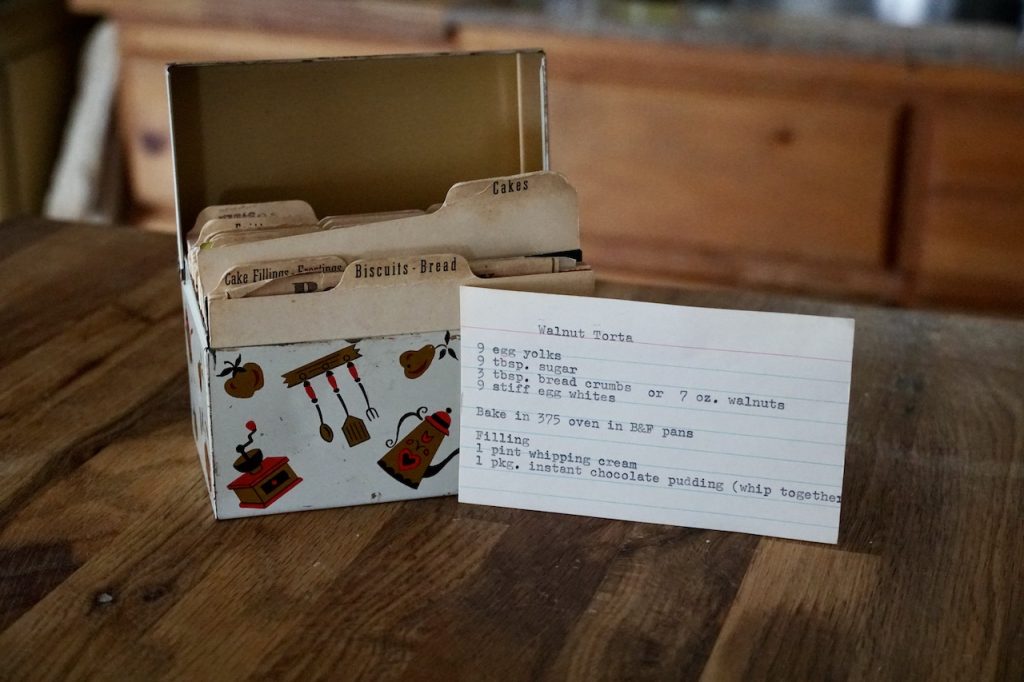 A vintage recipe boy with a recipe card for walnut torte.