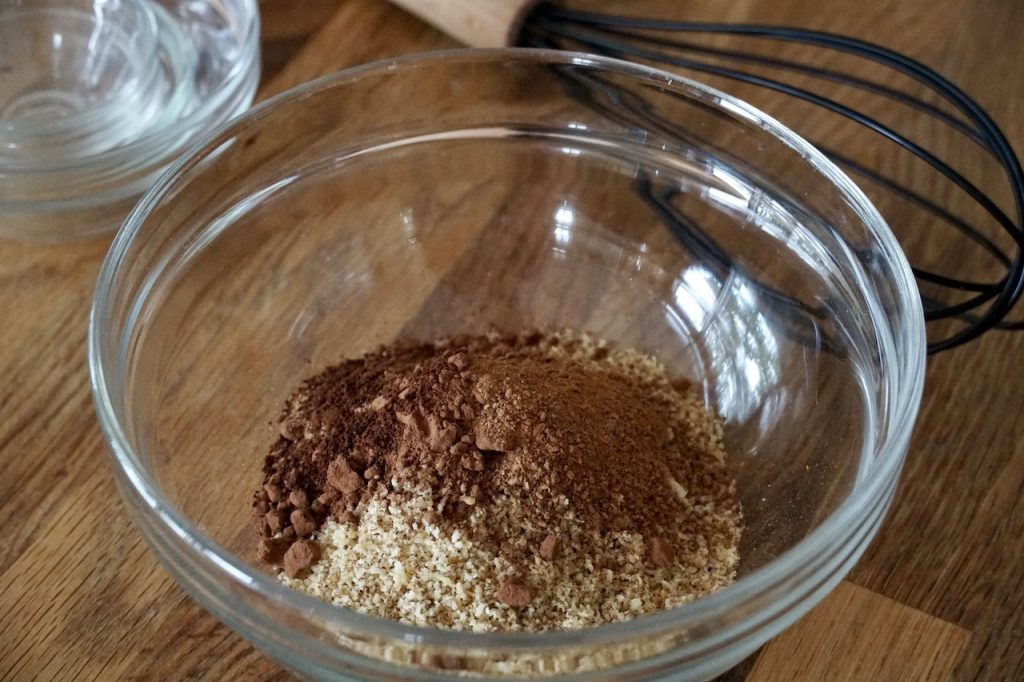 The ground walnuts, cocoa powder and spices spilled into a large bowl.
