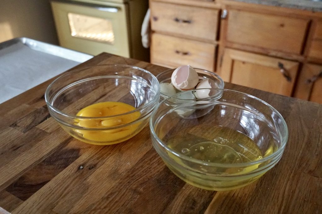 The egg whites and egg yolks separated into two bowls.