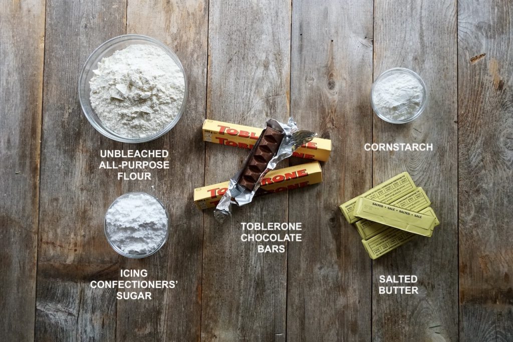 The ingredients for Chocolate Shortbread Cookies include Toblerone chocolate, flour, icing sugar, cornstarch and butter.