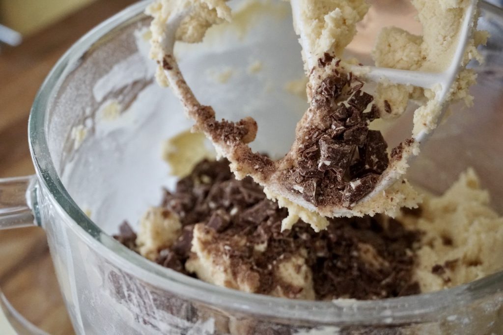 The cookie dough topped with morsels of chopped Toblerone chocolate car.