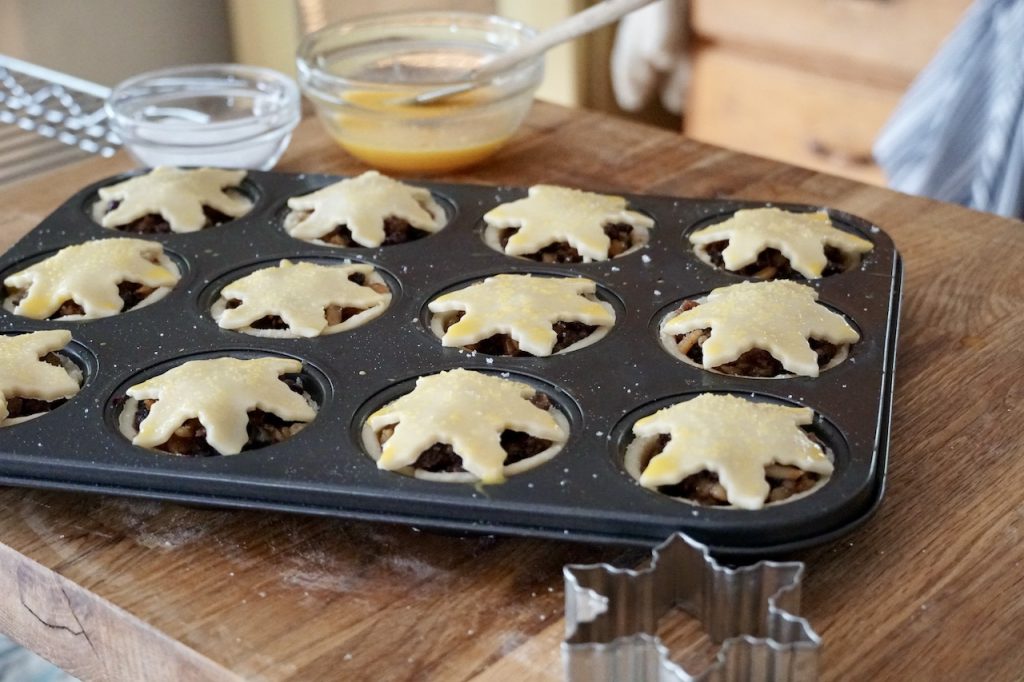 The individual mince pies brushed with egg and sprinkled with sugar.
