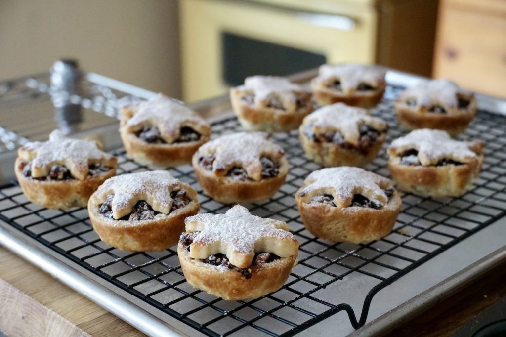 Individual Mince Pies dusted with icing sugar.