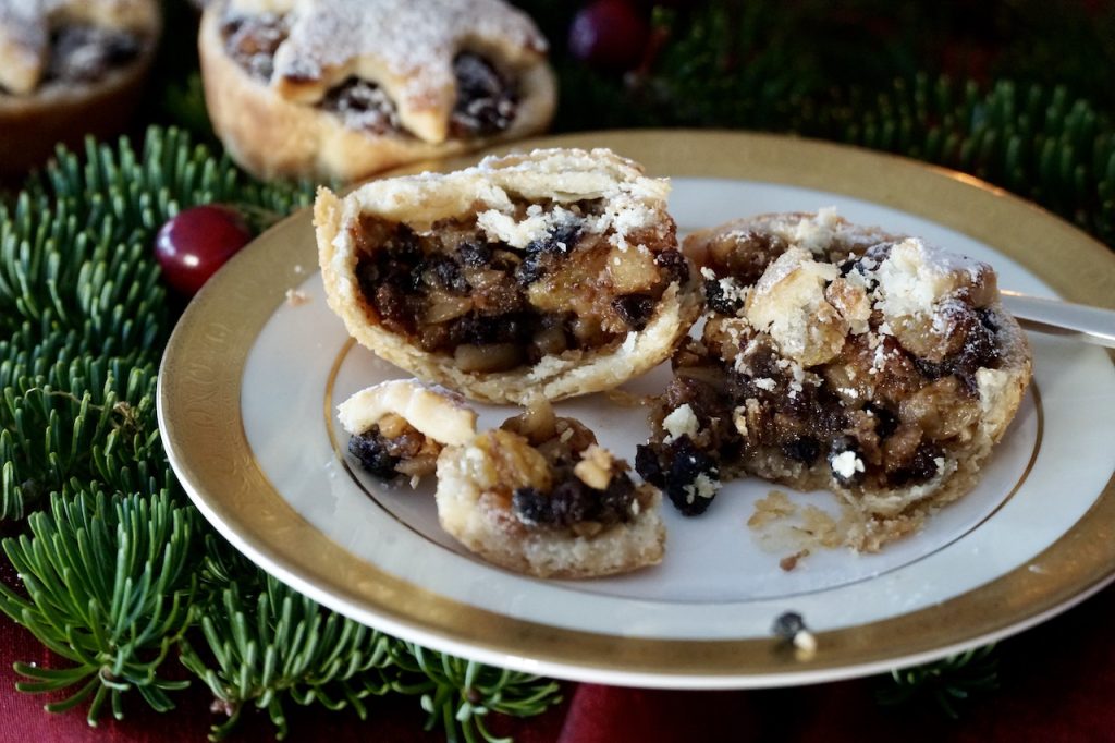 One of the Individual Mince Pies cut open to reveal the scrumptious interior of mincemeat in flaky pastry.