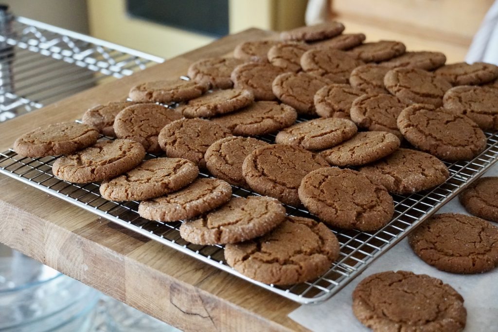Soft and chewy ginger cookies cooling on a wire rack.