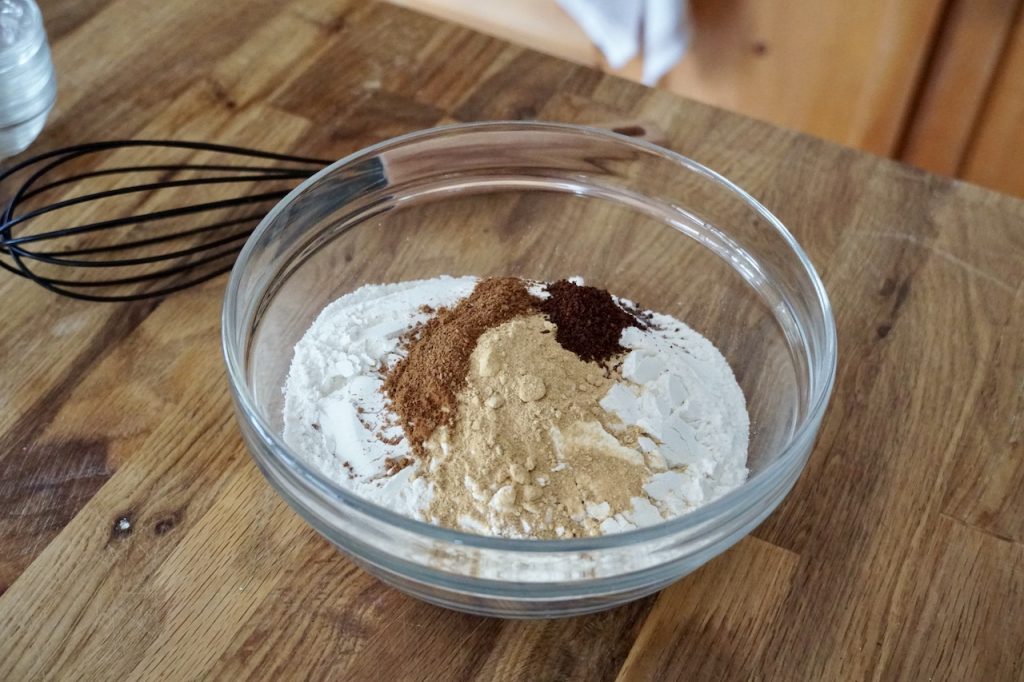 Flour, baking soda, kosher salt and the various spices assembled in a medium mixing bowl.