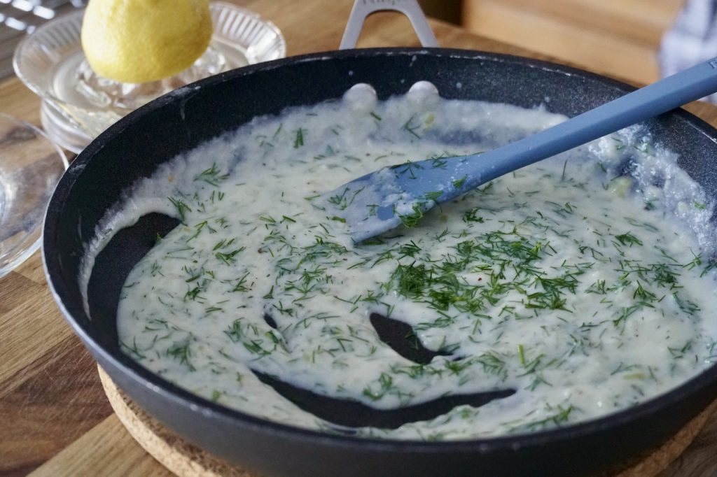 A skillet of creamy dill sauce