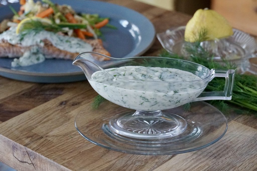A gravy boat filled with creamy, Lemony Dill Sauce.