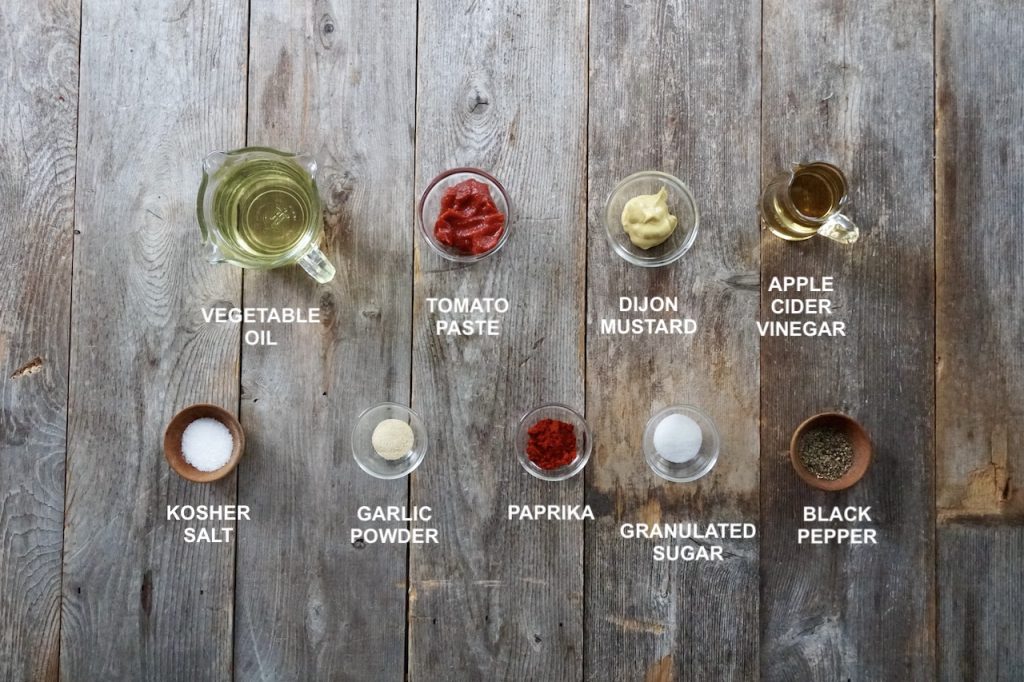 Ingredients needed to make a homemade French dressing include: oil, vinegar, Dijon, tomato paste, seasoning, paprika, garlic powder and a tiny bit of sugar.