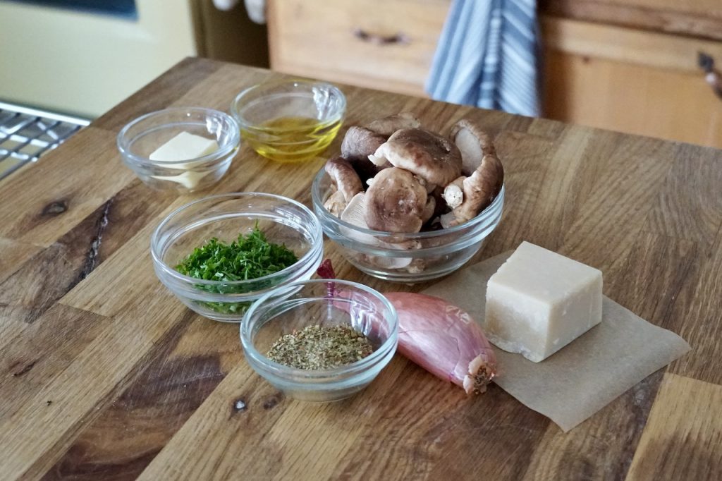 A shallot, chopped parsley, WATC Salad Sprinkles, shiitake mushrooms, Parmesan and seasoning.