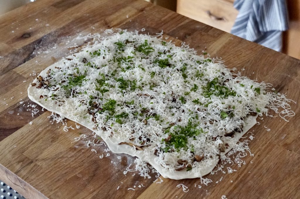 A rectangle of the pastry dough topped with the sautéed mushrooms, cheese and seasonings.