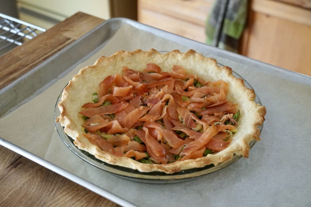 Strips of smoked salmon laid onto the sautéed veggies.