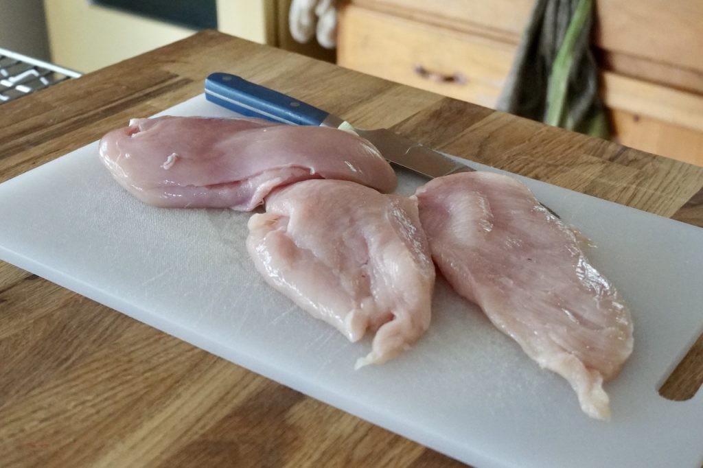 Two skinless, boneless chicken breasts, cut in half to create chicken cutlets.