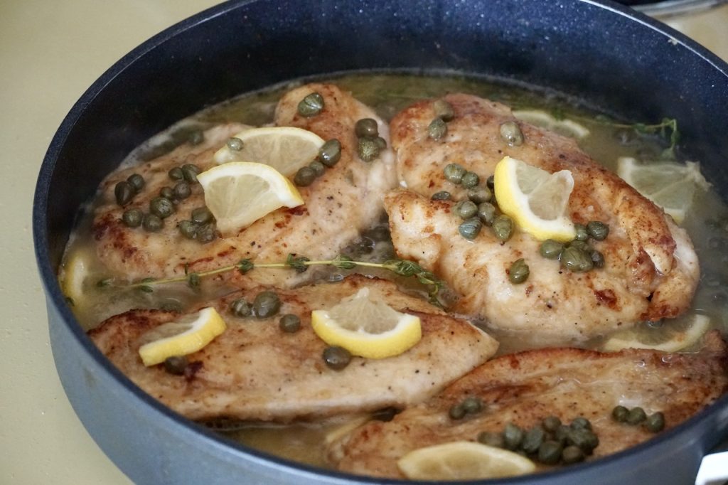Lemony Chicken Piccata recipe finished and bubbling away in a large skillet.