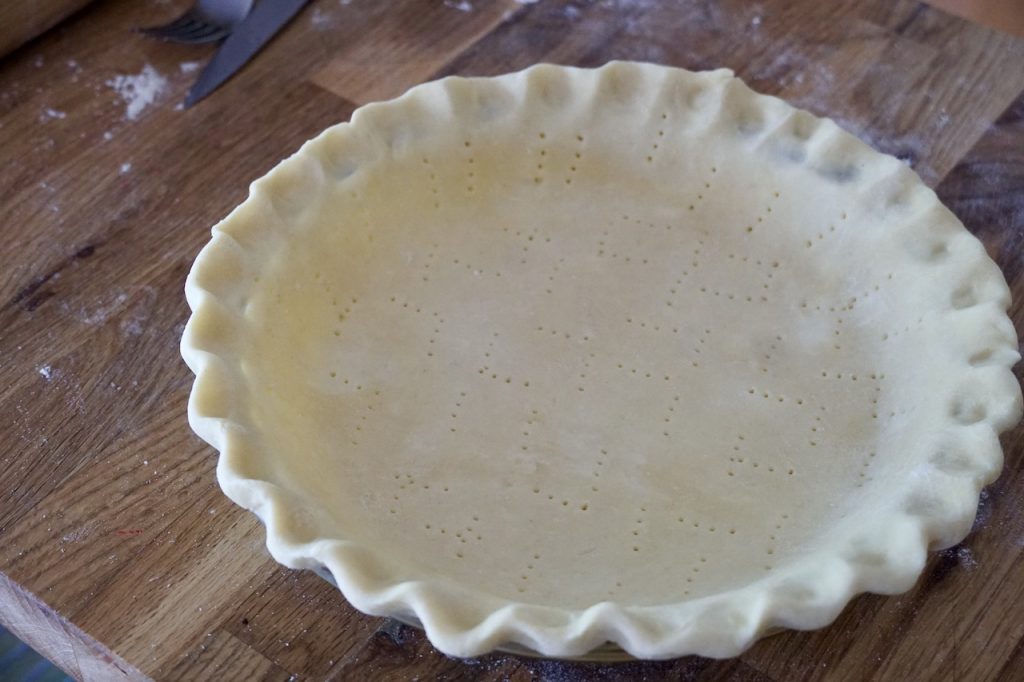 A pie plate filled with a chilled all-butter pie crust.