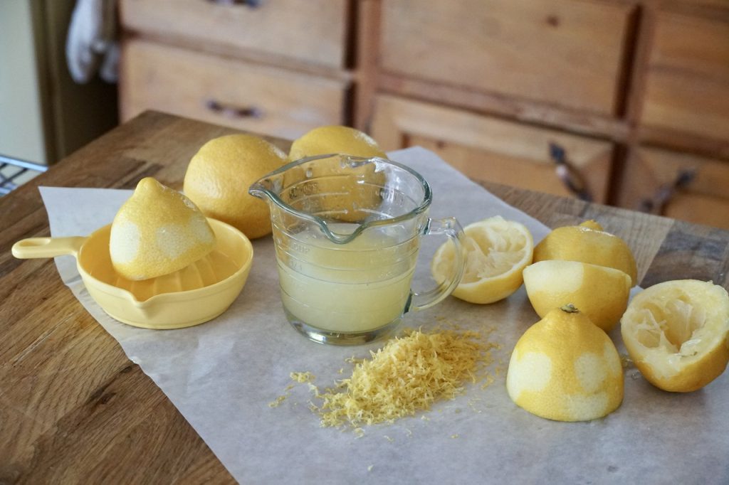 A group of lemons juiced and zested for a lemon custard pie recipe.