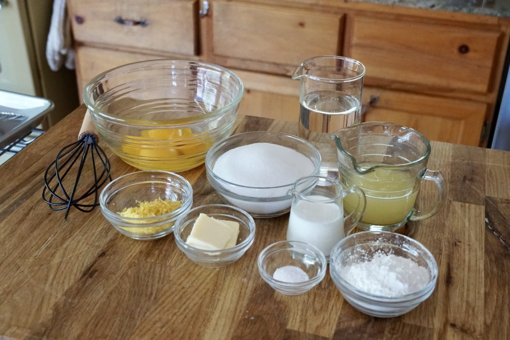All of the ingredients for e lemon curd custard placed into bowls.