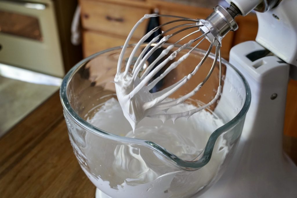 The whipped meringue after being prepared in a stand mixer.