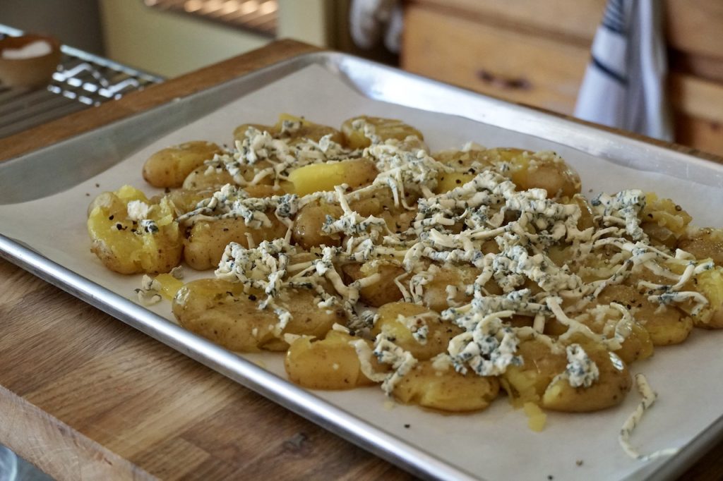Fingerling potatoes brushed with garlic butter topped with grated blue cheese.