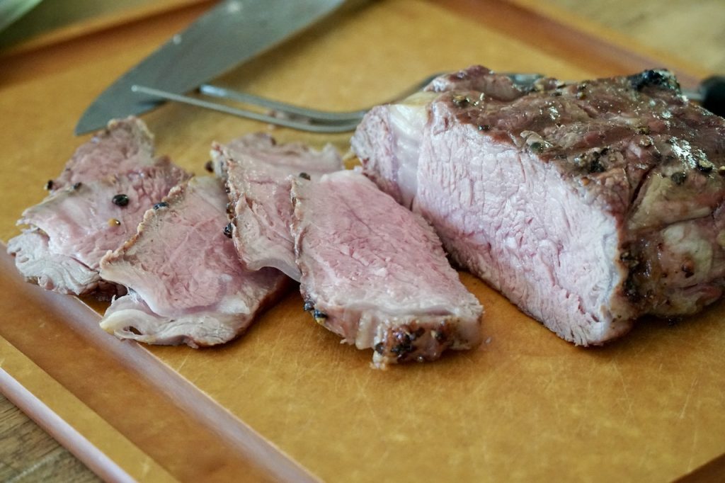 The Grilled Veal Rib Chops thinly sliced showing medium-rare doneness.