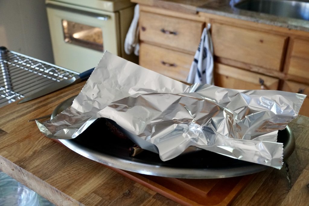 The rib chops covered loosely with foil, resting for a few minutes.