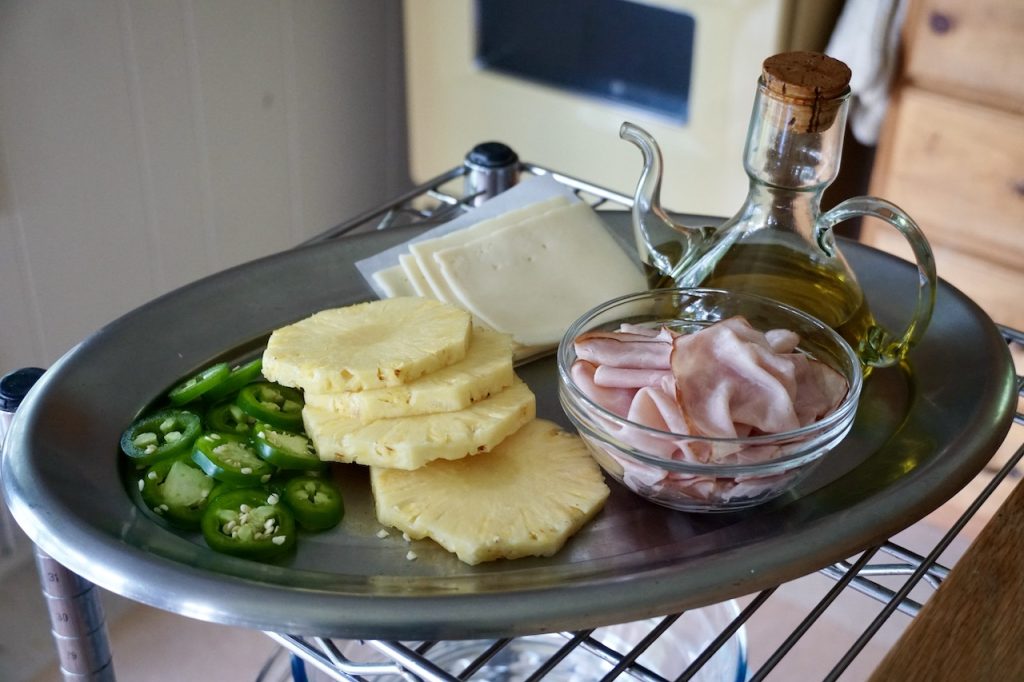 The burger toppers needed to be grilled assembled on a platter: pineapple slices, sliced jalapeño, Swiss cheese and shaved ham.