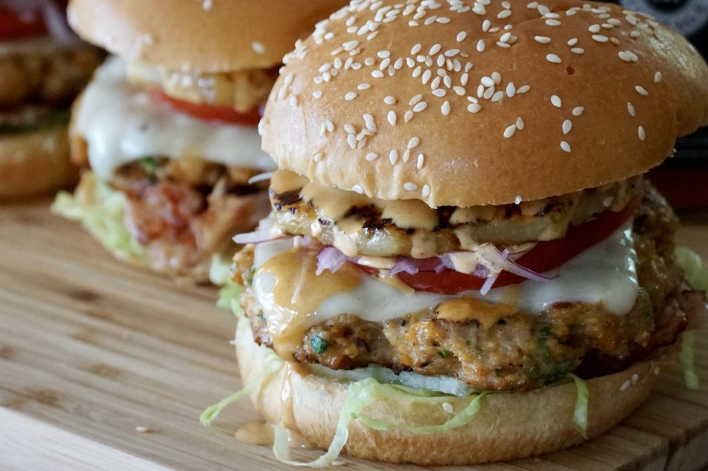 Close up of the various toppings stacked to create the best Hawaiian Chicken Burger.
