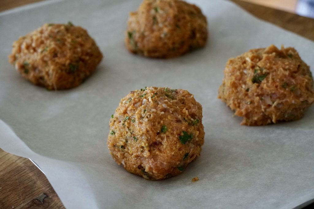 The chicken patty mixture portioned into balls before be flattened into patties.