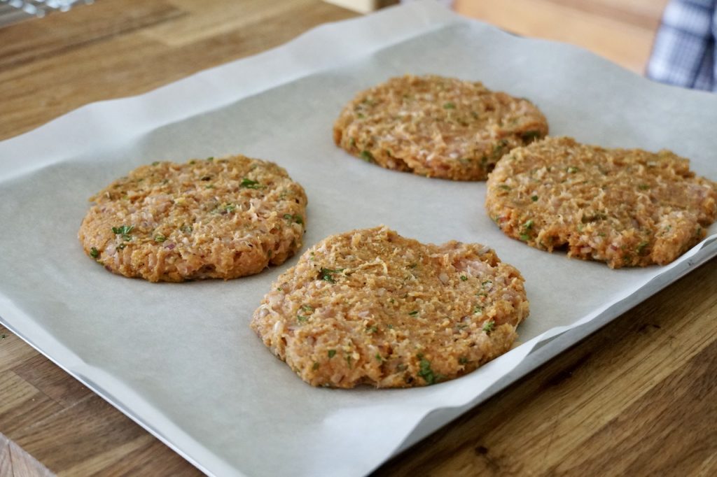 Grilled Hawaiian Chicken Burger patties ready to be chilled before being cooked.