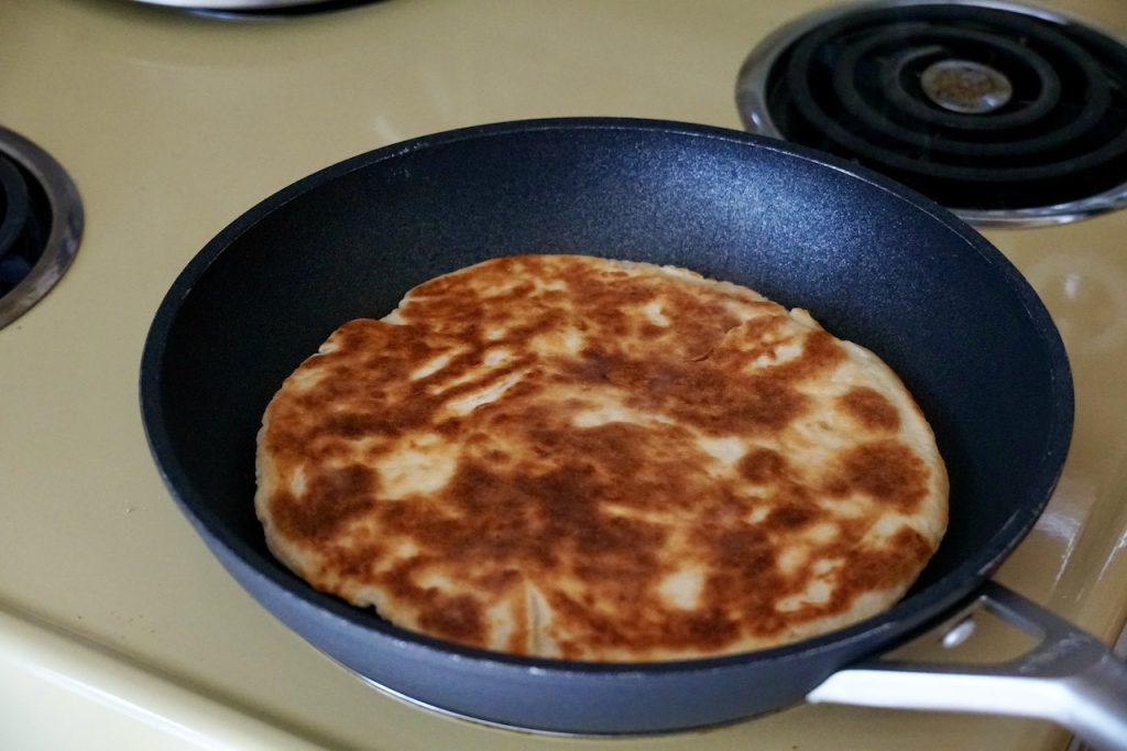 The flatbread flipped in a large skillet.
