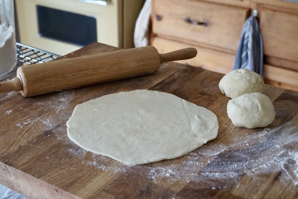 One of the dough balls rolled out to a 9-inch round flatbread.