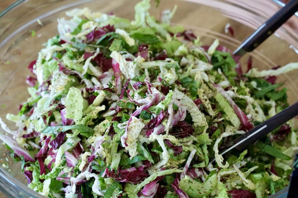 A close up of the veggie slaw with a sprinkle of seasoning.