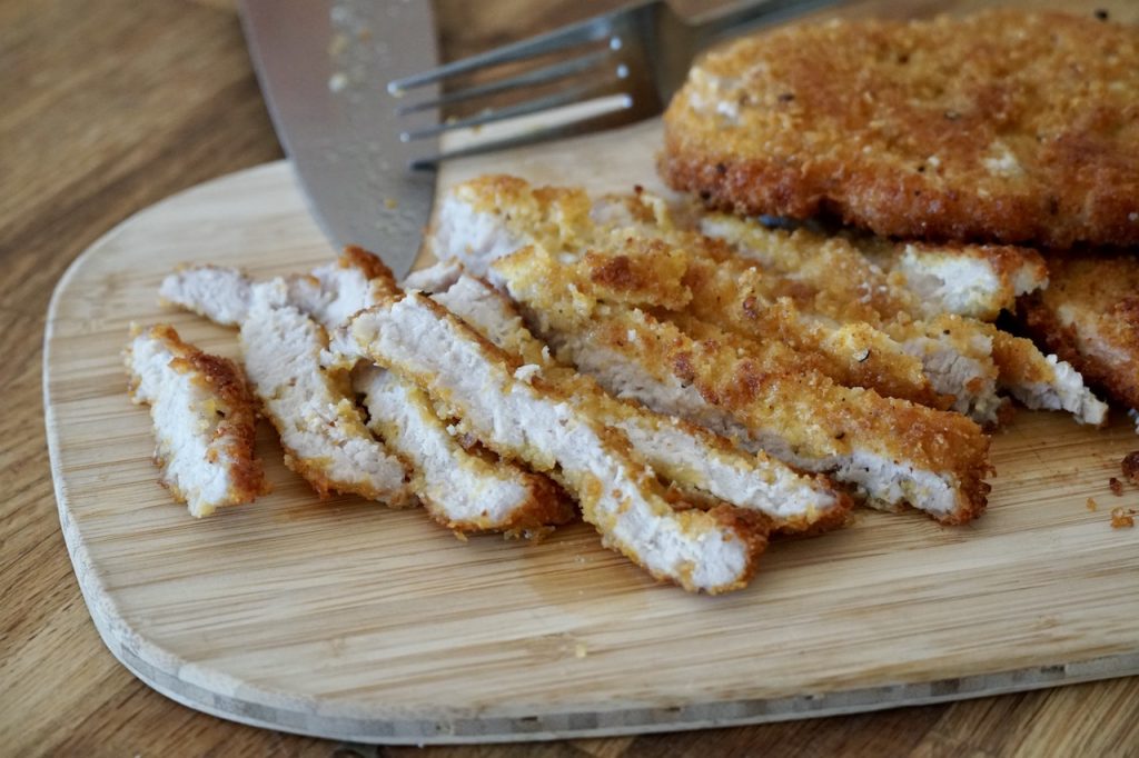 Slices of crispy pork cutlets breaded with corn flake crumbs.