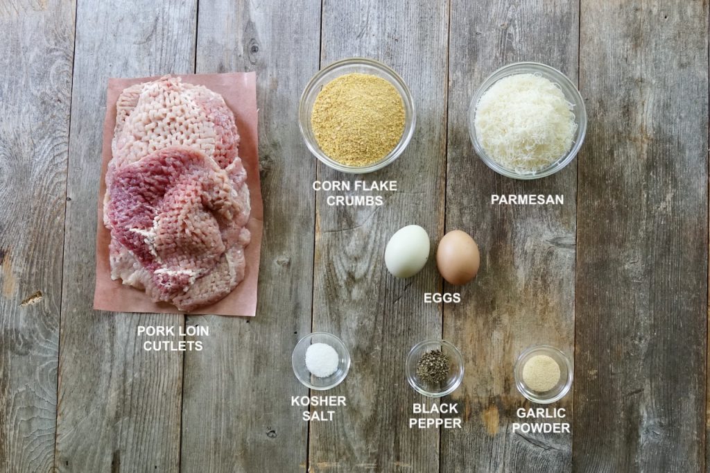 The ingredients needed to make schnitzel include the pork loin, crumbs, cheese and seasoning.