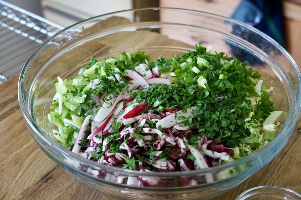All of the vegetables for the slaw assembled in a large bowl.