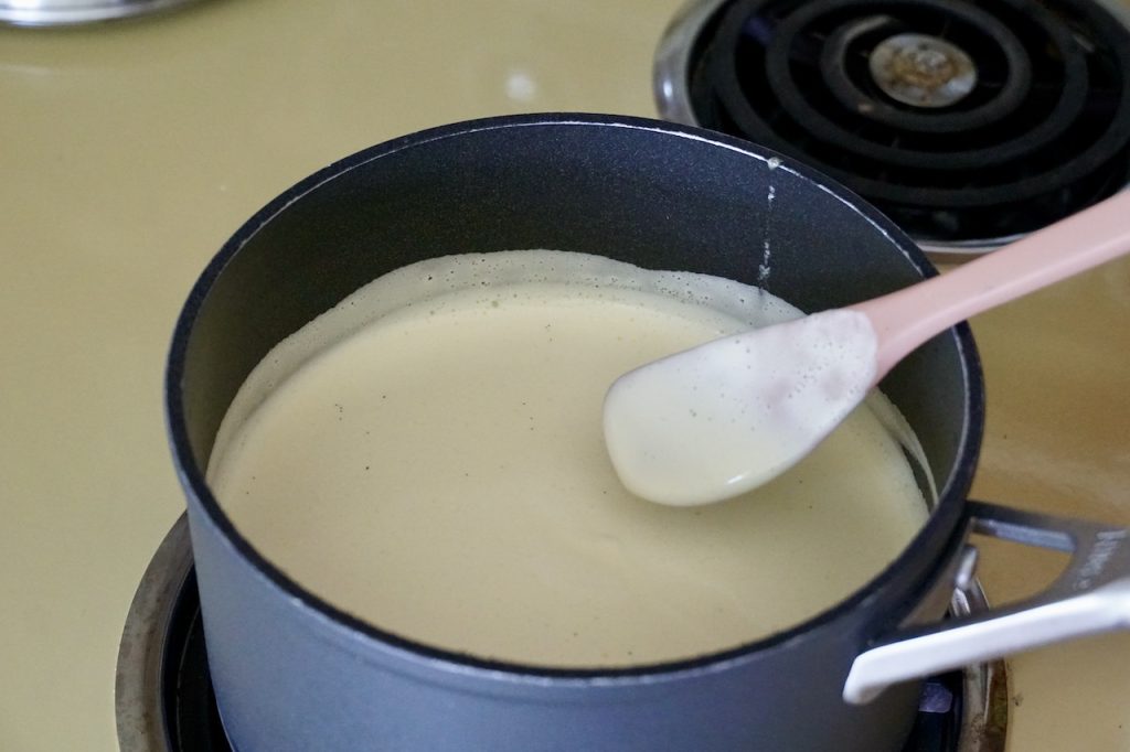 The vanilla custard cooking in a large saucepan.