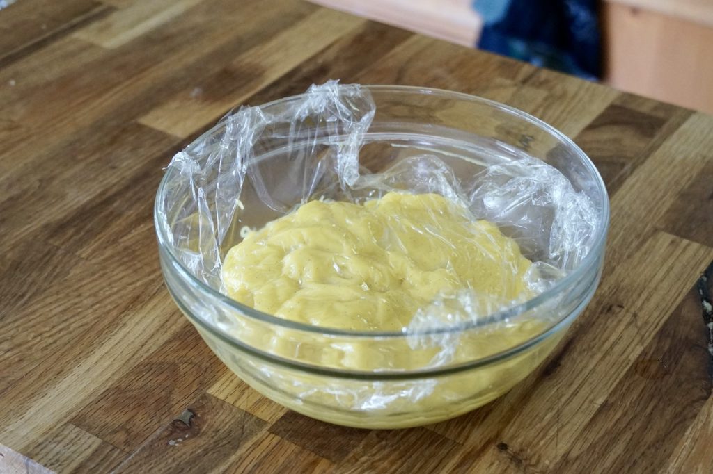 The vanilla custard covered with plastic wrap as it cools.