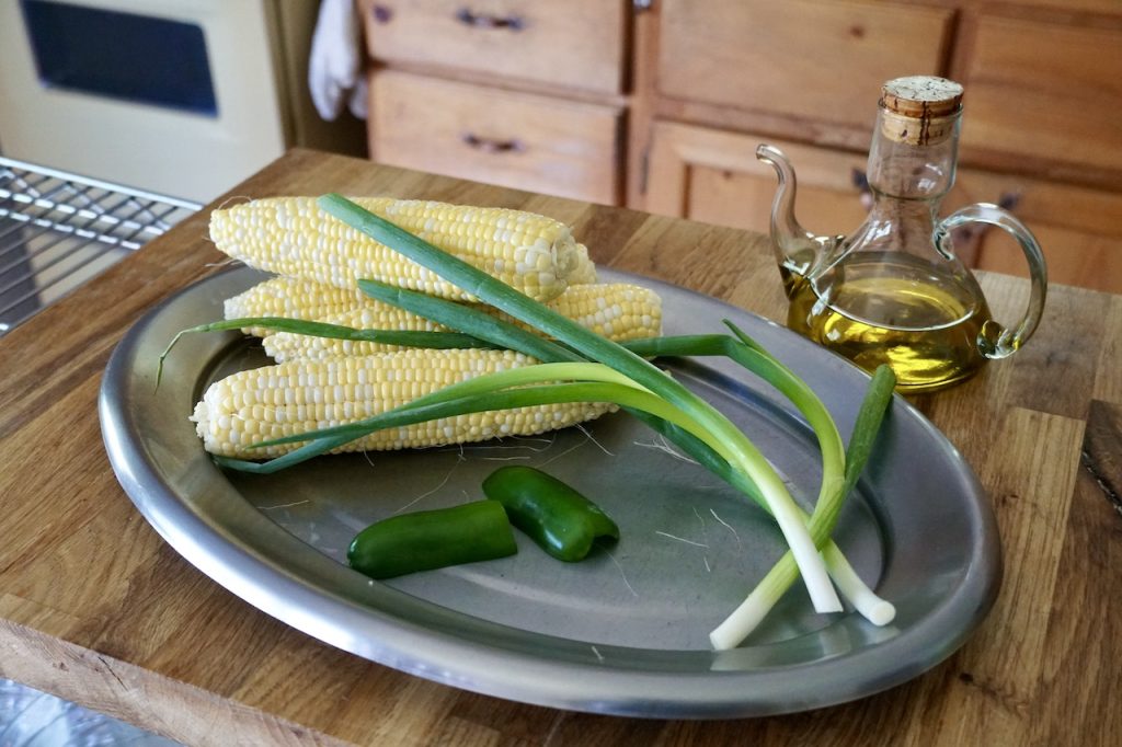 Ears of corn, green onions and a jalapeño pepper.