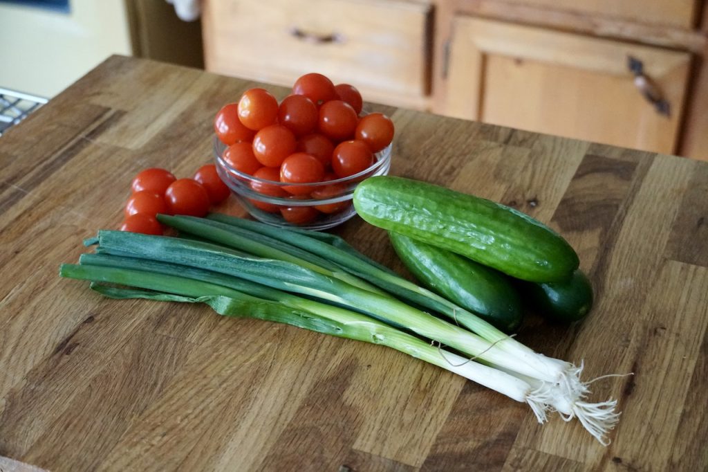 Sweet cherry tomatoes, mini cucumbers and green onions.