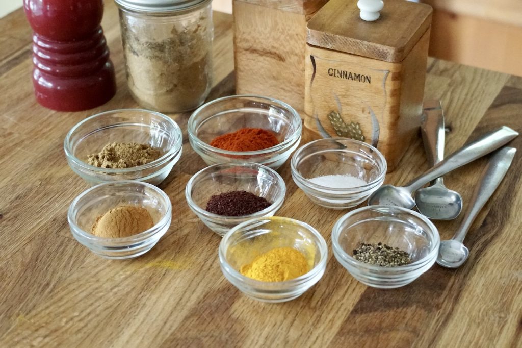 The assorted spices for kofta kebabs include: cinnamon, turmeric, sumac, cumin, paprika, salt and pepper.