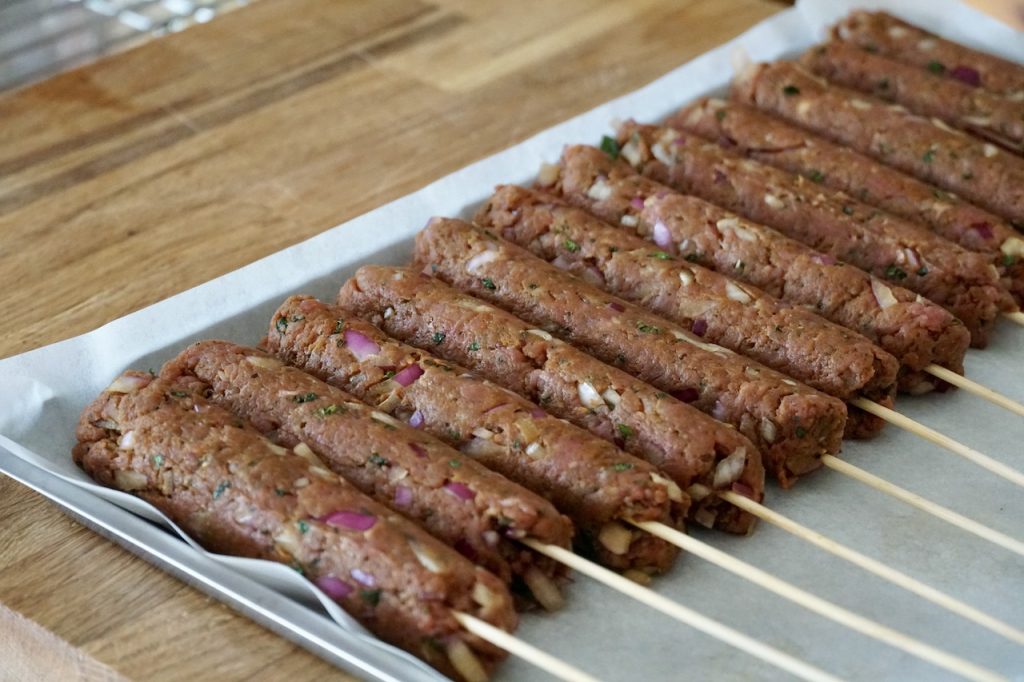 Veal kofta kebabs ready to be refrigerated.