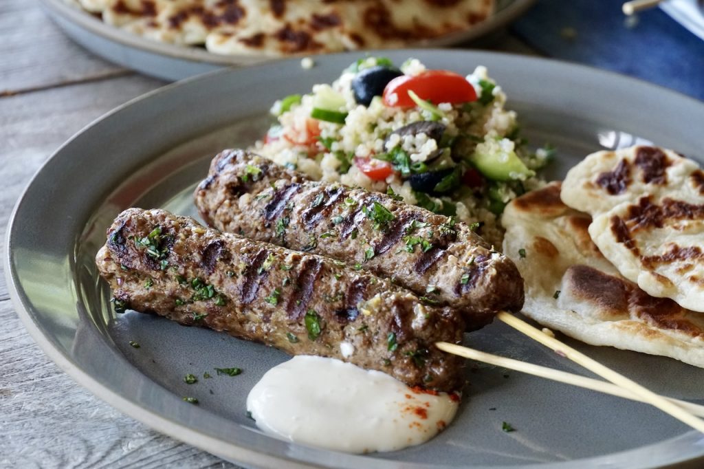 Veal Kofta Kebabs served with an easy summer salad and warmed flatbreads.