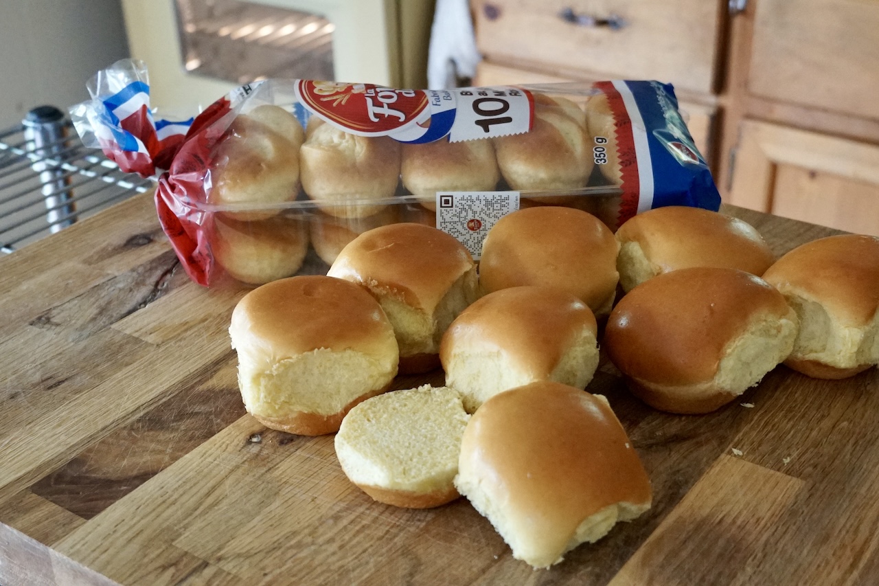 Mini brioche slider buns cut in half, ready to be toasted.