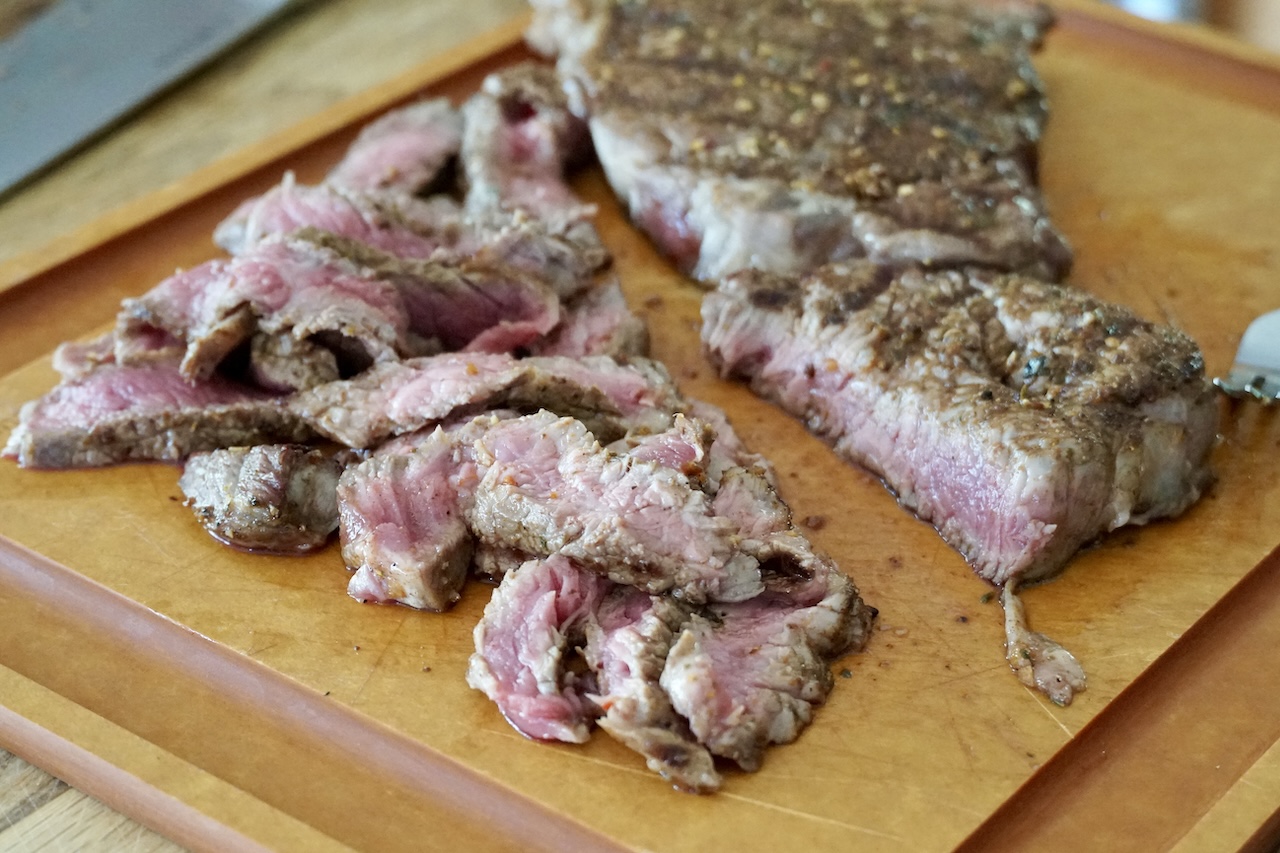 The grilled ribeye steaks cut thinly.